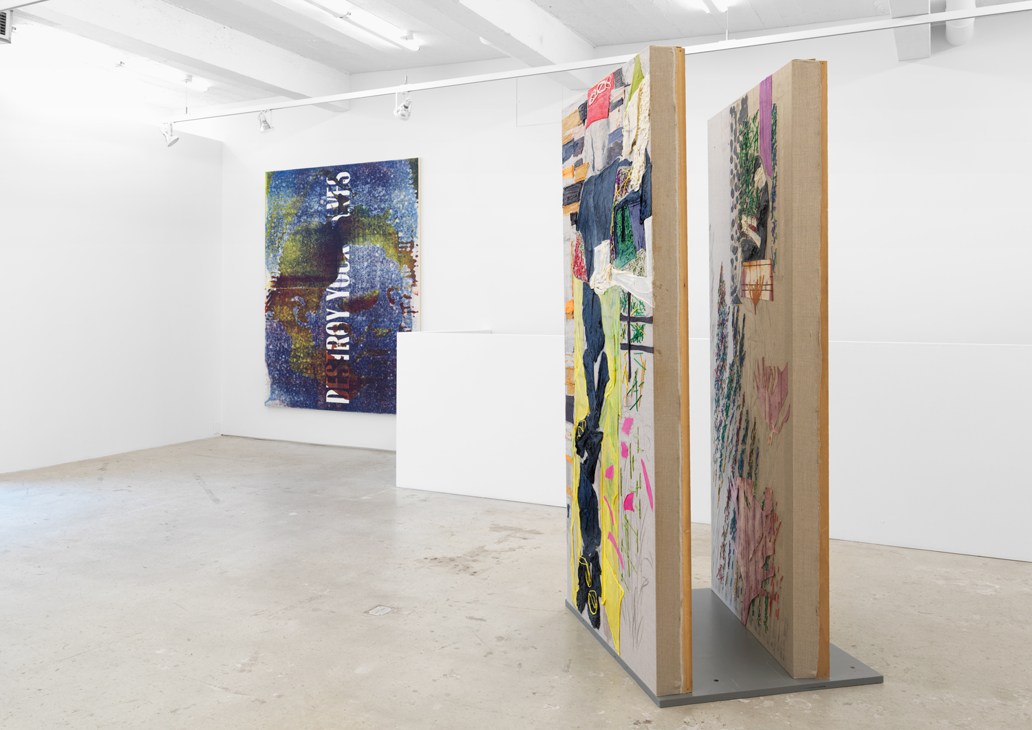 Israel Lund, Untitled (SEVERED HEAD DESTROY YOURSELVES) (left), 2018, acrylic on raw canvas, 88h x 68w in.  Dona Nelson, By The Yard (right), 2016, collage, dyed cheesecloth, muslin, and acrylic mediums on linen panel mounted on plywood base, panel: 81.5 x 36 in, base: 38 x 32 in.